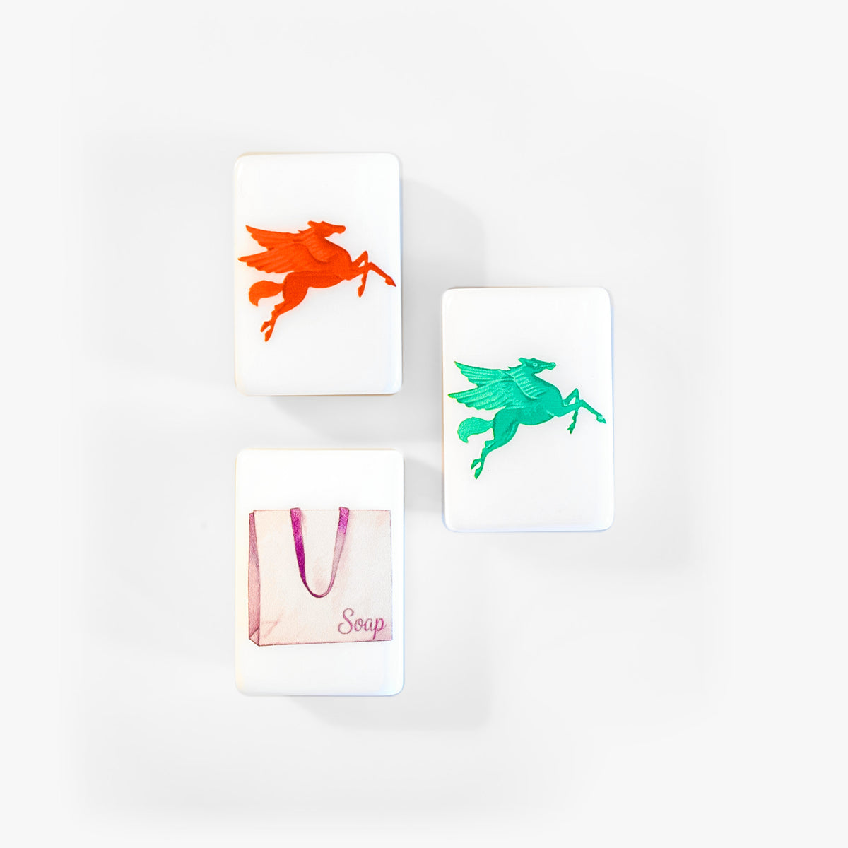 Dragon tiles from The Dallas Collective: a red Pegasus, a green Pegasus and a white shopping bag labeled Soap
